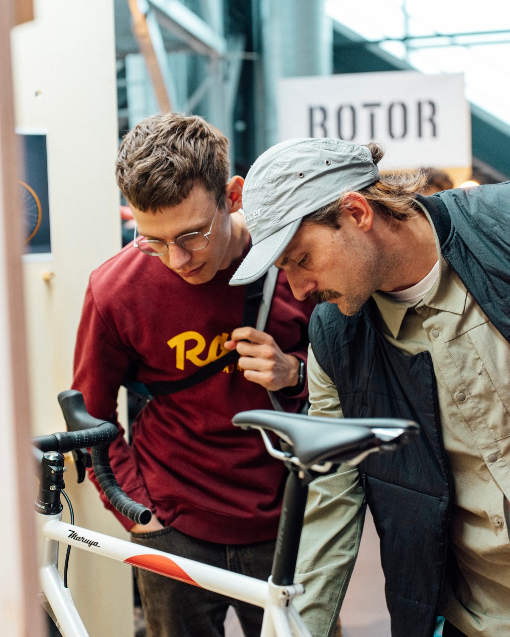 Two visitors examining a bespoke bicycle on the Bespoked show floor