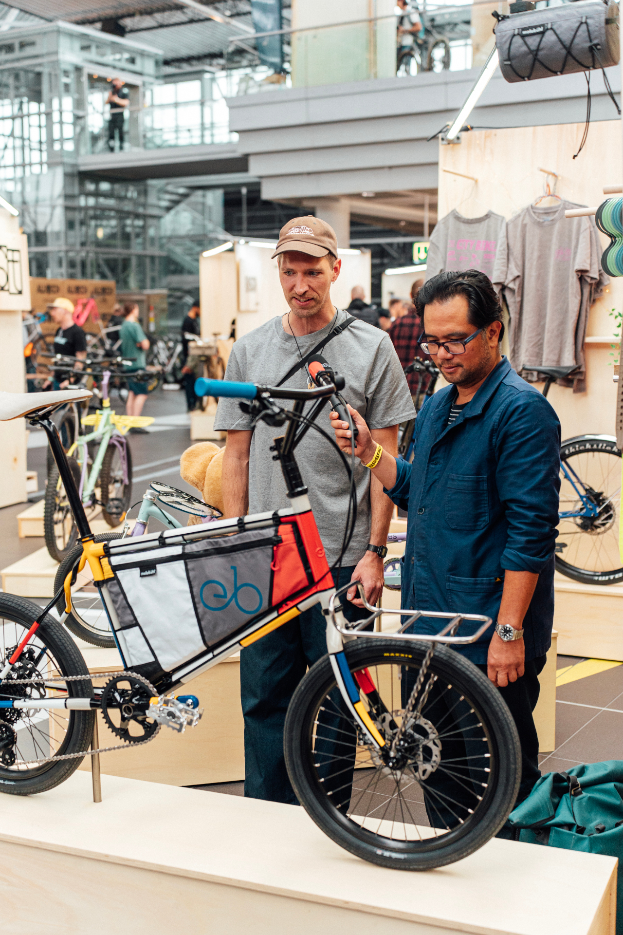 Two visitors examining a bespoke bicycle on the Bespoked show floor