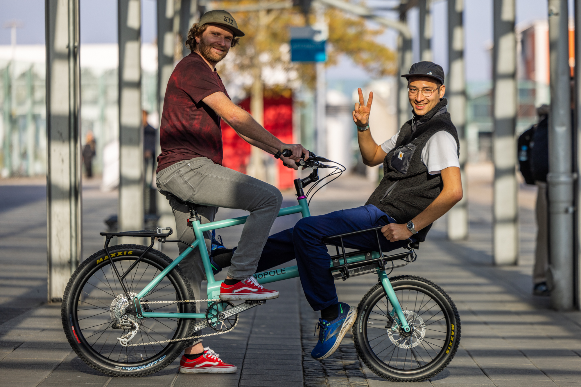 Two riders on a Monopole cargo bike outside the venue
